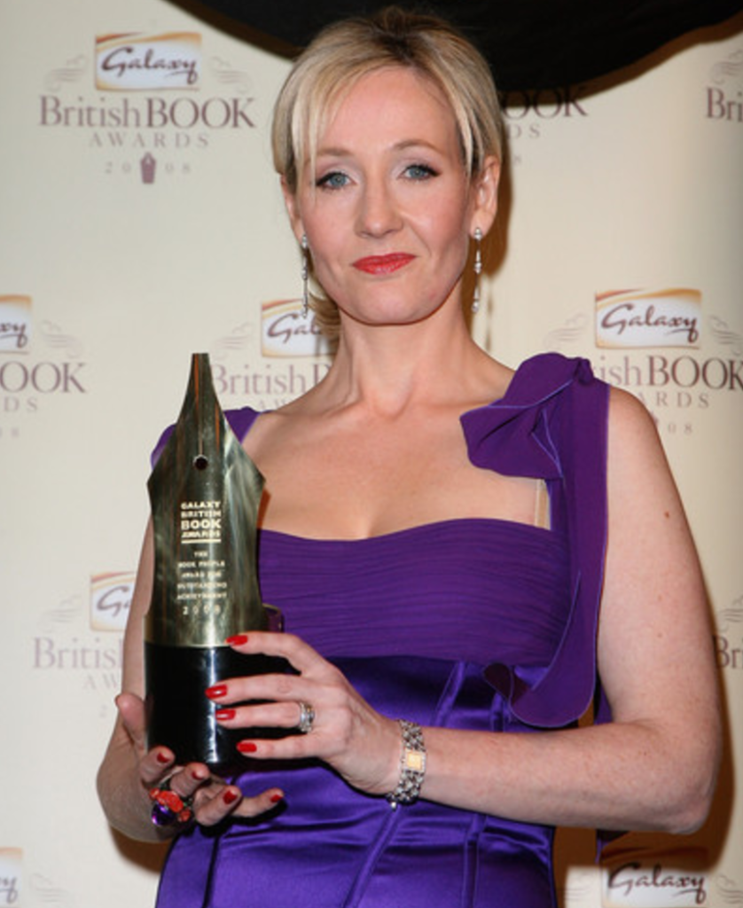 Author JK Rowling holding an award