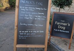 A wooden chalk board for the pub The Farmer's Dog